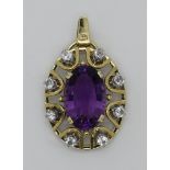 1 Anhänger GG 14ct. mit ovalem Amethyst ca. 1,6x1cm und lt. EL weißen Saphiren, Gesamtlänge ca. 3,5c