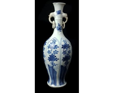 A Chinese blue and white porcelain two handled ring neck bottle vase, the slender neck applied with unglazed ring handle with