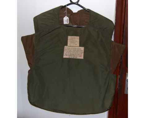 A post-WWII British Army issue armoured vest, bearing War Department label with broad arrow, dated 1954