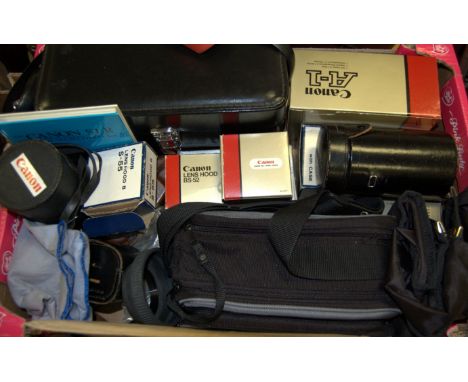 A large collection of assorted cameras and camera equipment to include; boxed Canon A1, Canon AT1, and a pair of Lieberman & 