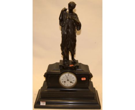Circa 1900 black slate mantel clock having enamel dial with Roman numerals and eight day movement, the whole surmounted by a 