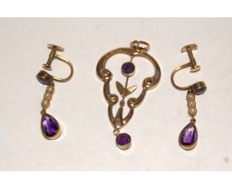 An Edwardian 9ct gold and amethyst set openwork pendant together with a pair of 9ct amethyst and seed pearl set ear clips (2)