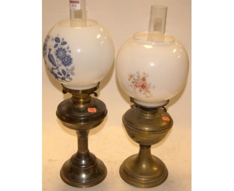An early 20th century brass pedestal oil lamp having an opalescent glass shade together with one other similar (2)