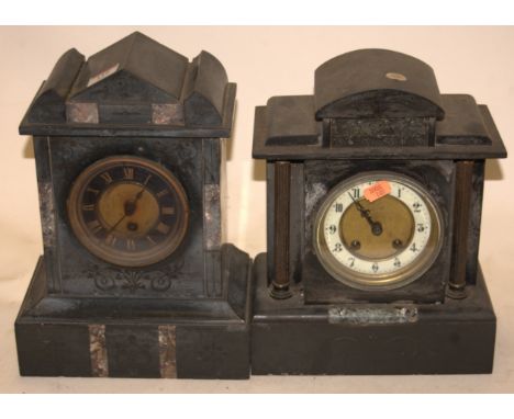An Edwardian black slate mantel clock of architectural form having an enamel dial with Arabic numerals and eight day movement