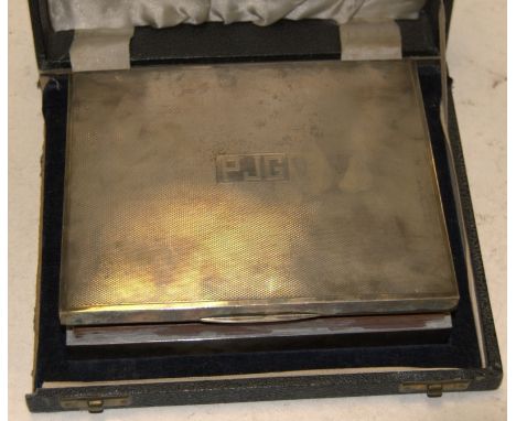 A mid-20th century silver cigar box, having engine turned hinged cover, monogrammed 'PJG', with lined wood twin division inte