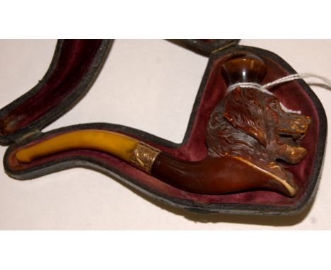 A Victorian meerscham pipe carved in the form of a dogs head having a yellow metal band, cased