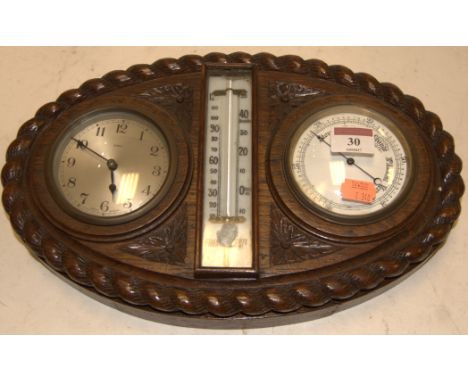 A late Victorian oak cased clock barometer, having central thermometer flanked by two dials, within ropetwist surround