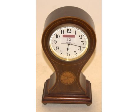 An Edwardian mahogany and satinwood inlaid cased balloon shaped mantel clock, having an enamelled dial with Arabic numerals a