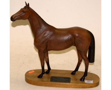 A Beswick model of Red Rum from the Connoisseur Horse series Model No. 2510, brown matt finish, on a wooden plinth with plaqu