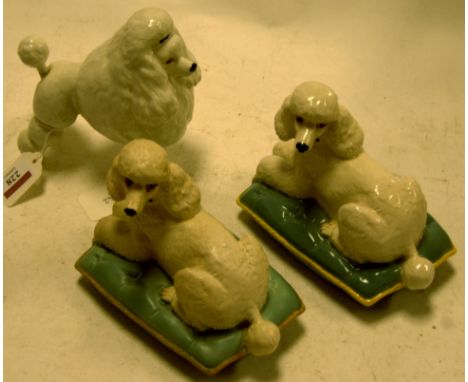 A Beswick model of a poodle 'Ebonit Av Barbette' No. 1294, white gloss finish (restoration to tail) together with  a pair of 