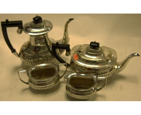 An early 20th century silver plated four piece tea and coffee service of half gadrooned oval form