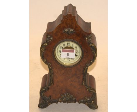 An early 20th century burr yew and gilt metal mounted mantel clock, having enamelled dial with Arabic numerals and cylinder m