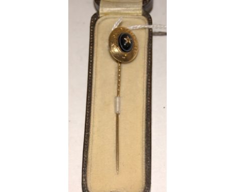 A 19th century yellow metal, black onyx, and diamond set mourning tie-pin, annotated 'In memory of', w.1.4cm, in fitted leath