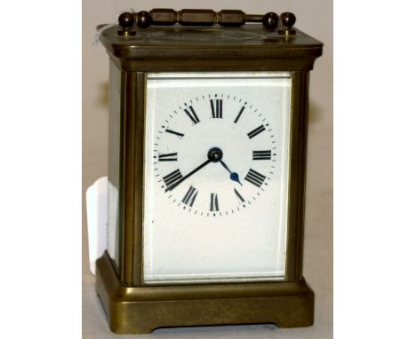 An early 20th century brass cased carriage clock having enamel dial with Roman numerals and visible platform lever escapement