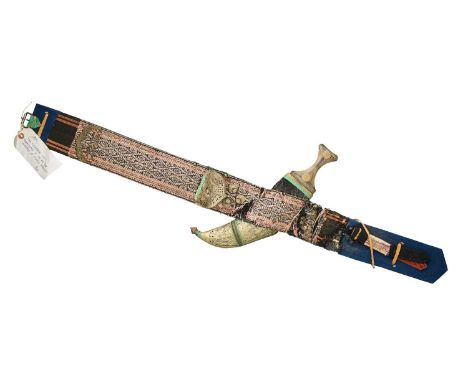 □ AN ARAB JAMBIYA, 20TH CENTURY with broad curved double-edged blade formed with a medial ridge on each face, shaped grip stu