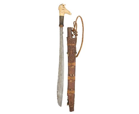 A DYAK SWORD (MANDAU), BORNEO, LATE 19TH CENTURY of characteristic form, with iron single-edged blade engraved with scrollwor