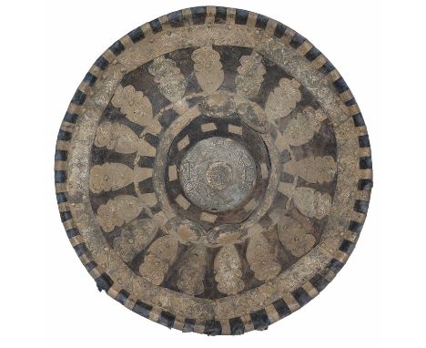 AN EAST AFRICAN WHITE-METAL MOUNTED HIDE SHIELD, LATE 19TH/20TH CENTURY of pronounced convex form rising to a circular centra