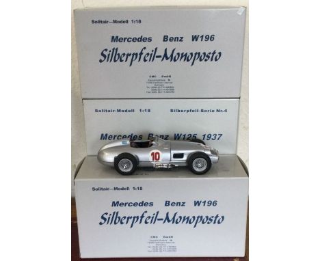 CMC: Three 1:18 scale boxed model racing cars. Est. £100 - £200.