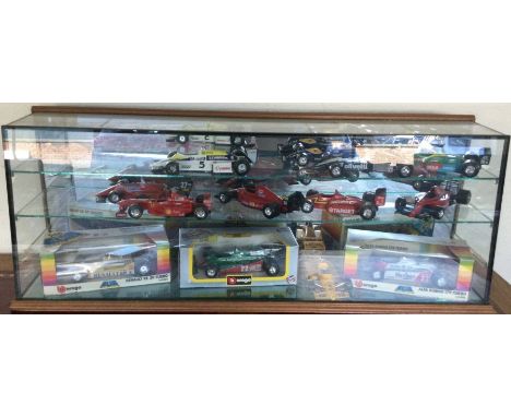 A large collection of various 1:18 scale unboxed model racing cars. Est. £20 - £30.