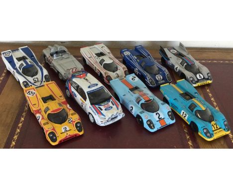 Nine various 1:18 scale unboxed model racing cars. Est. £20 - £30.