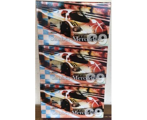 RACING LEGENDS: Three various 1:18 scale boxed model racing cars. Est. £40 - £60.