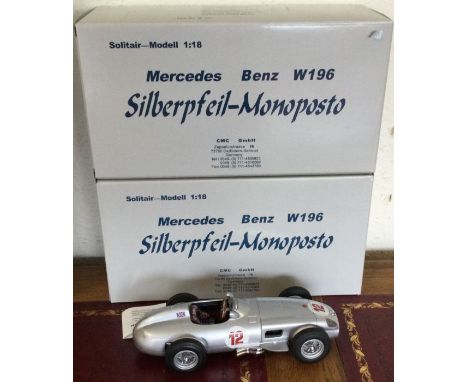 CMC: Two 1:18 scale boxed model racing cars. Est. £100 - £200.