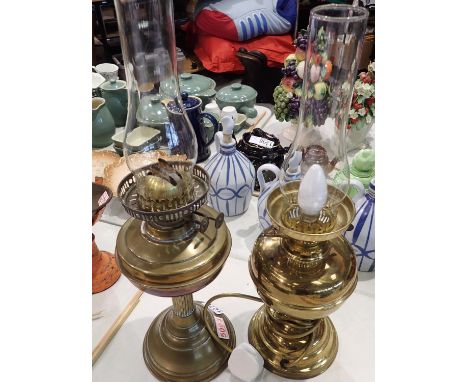 Two brass antique oil lamps, one converted to electric, largest H: 55 cm. Not available for in-house P&amp;P, contact Paul O'