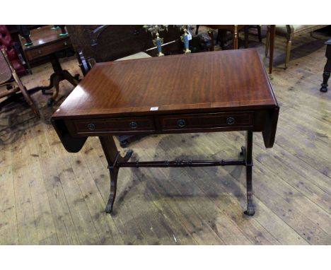 Mahogany and line inlaid two drawer sofa table on reeded tapering ends and brass paw feet