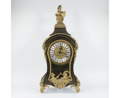 A Louis XV-style cartel clock of black-painted wood decorated with a classical figure and rich gilt decorations, finely chise