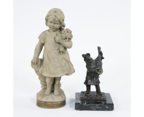 Collection of a bronze in black patina The musician, signed Rousseau and a terracotta figurine Flower girl signed Gustave VAN