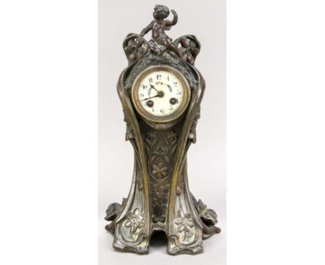 Jugendstil-Tischuhr um 1920, Bronze, florale Motive mit oben sitzendem Putto, weißes Emaille-Zifferblatt mit polychromer Rank