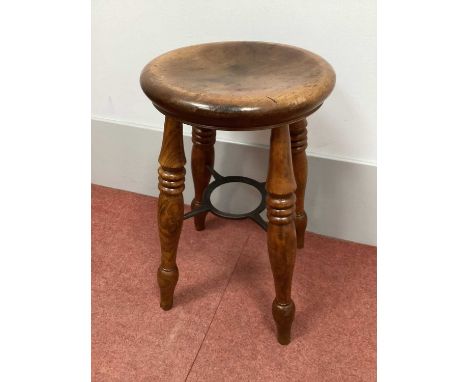 A Late XIX Century Birch Boston Stool, the gently dished circular seat supported by four turned legs united by an iron stretc