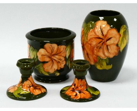 A Moorcroft Pottery Vase, of extended ovoid form, painted in the 'Coral Hibiscus' pattern against a green ground, signed in g