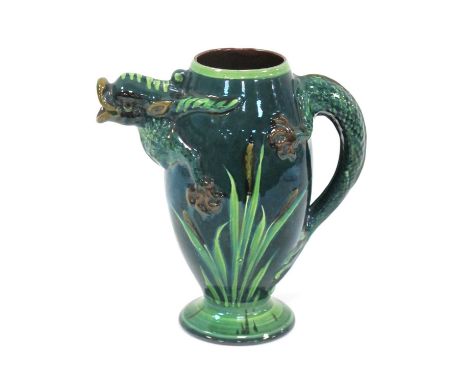 An Aller Vale Pottery Ewer, the ovoid body moulded and painted with bullrushes against a green ground, the handle and spout i