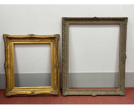 A Gilt Gesso Picture Frame, with moulded scrolling floral decoration, 107 x 65cm; Another, with gadroon and foliate decoratio