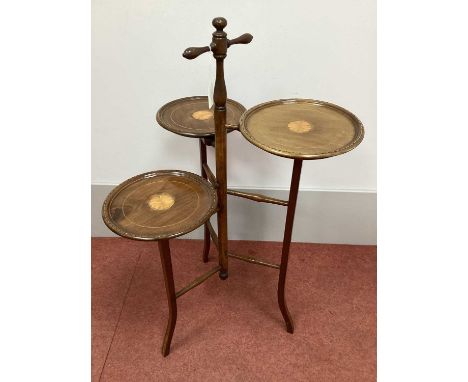 An Edwardian Mahogany Triform Cake Stand, with batwing inlay to the three circular dished trays, turned handle and ladder sup