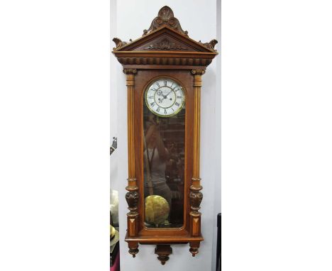 A Vienna Wall Clock, with carved pillars and pediment, the circular dial with black Roman numerals and inscribed Math Meindl,