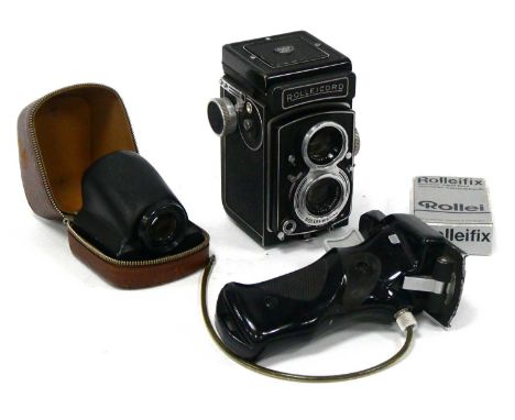 A Rolleicord Rollei-Werke Twin Lens Camera by Franke &amp; Heidecke, together with Rollei Pentaprism, tripod head and handle.