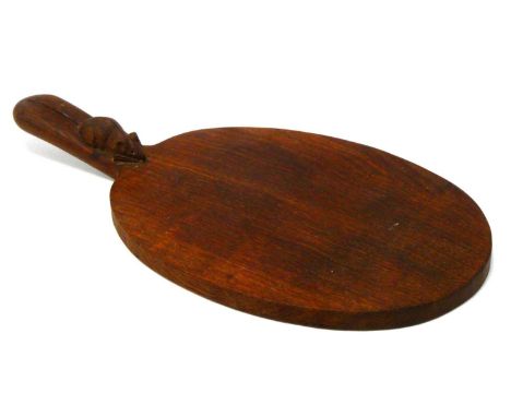 A Robert Thompson 'Mouseman' Oak Cheese Board, of oval form with carved mouse signature to handle, 39cm long.