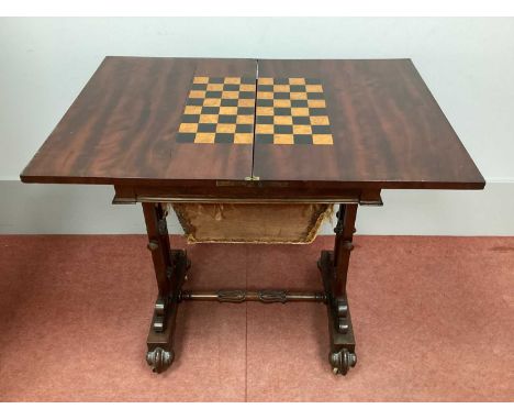 A XIX Century Mahogany Sewing/Games Table, the swivel top with boxwood stringing and inlaid with fleur-de-lys, the interior w