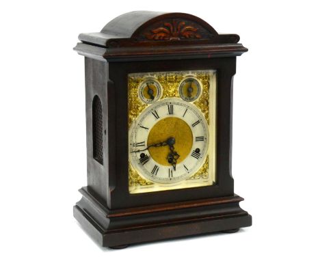 An Early XX Century Mantle Clock, the stained wood case with carved pediment, the dial with silvered chapter ring with Roman 