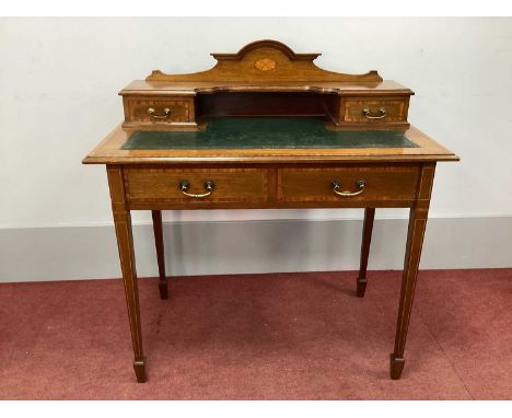 An Edwardian Inlaid Writing Table, with an arched pediment and two small upper drawers, green leather sciver over two lower d