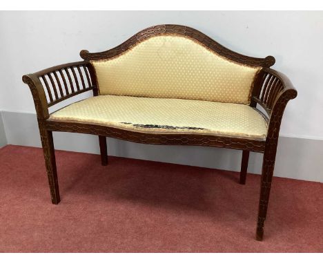An Early XX Century Mahogany Salon Seat, the arched top rail with blind fret decoration, upholstered back and seat, serpentin
