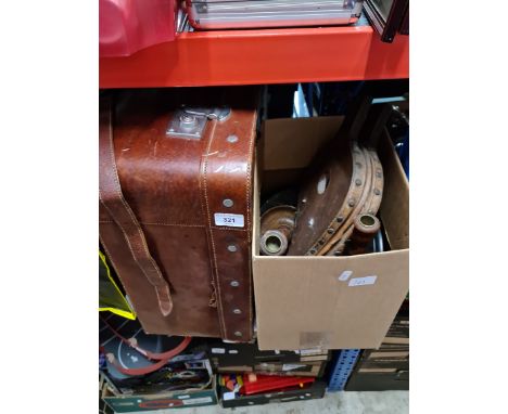 A box of treen to include wooden stands, candlestick holders, bellows and a leather luggage carrier. 
