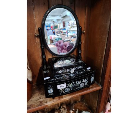 An modern black lacquer and mother of pearl dressing table mirror. 