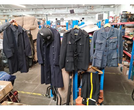 Various military and constabulary clothing items to include trench coat, hat, uniforms, etc. 