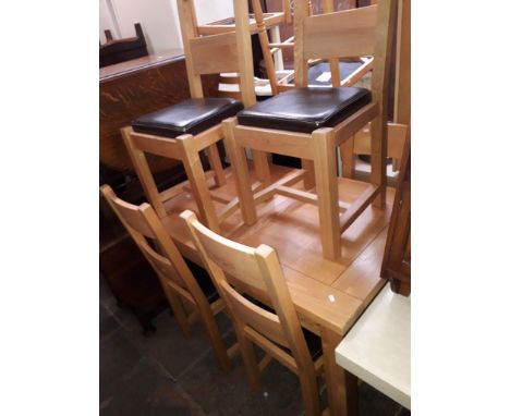 A light oak dining table and six chairs. 