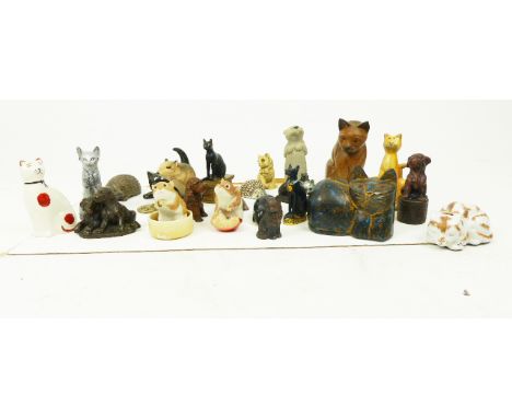 A collection of figures of cats, dogs and hedgehogs, mainly ceramic and resin.