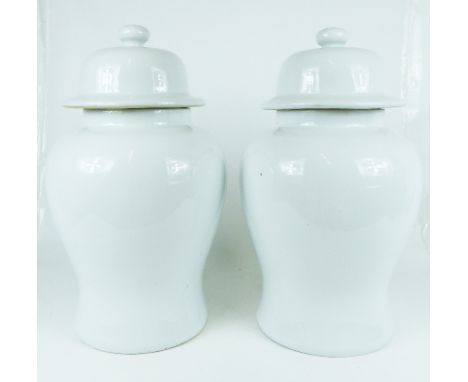 A pair of very large, Chinese, 20th century, white jars and covers with a round, knob finial on both lids, bulbous bodies and