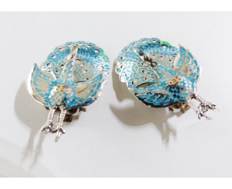 A pair of silver and enamel earrings.